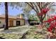 Beautiful backyard with mature trees, a hammock, enclosed porch, and tropical foliage at 592 Deer W Run, Palm Harbor, FL 34684