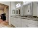 Bathroom boasting dual vanities, granite countertops, decorative mirrors, and modern fixtures at 592 Deer W Run, Palm Harbor, FL 34684