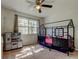 Charming bedroom with a fun black loft bed, toy kitchen, ceiling fan and a large window for natural light at 592 Deer W Run, Palm Harbor, FL 34684