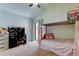 Charming bedroom features a bunk bed, desk, and sliding door leading to a balcony at 592 Deer W Run, Palm Harbor, FL 34684