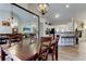 Open concept dining room with vaulted ceiling connected to kitchen and living room for easy entertaining at 592 Deer W Run, Palm Harbor, FL 34684