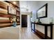 Inviting entryway features stylish wood paneling, light floors, and a decorative console table at 592 Deer W Run, Palm Harbor, FL 34684