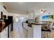 Modern kitchen with black appliances, granite counters, and an open view to the living room at 592 Deer W Run, Palm Harbor, FL 34684