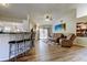Open-concept living room with vinyl floors, comfortable seating, and a sliding door to the backyard at 592 Deer W Run, Palm Harbor, FL 34684