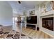 Spacious living area with fireplace, light vinyl floors, and open layout to the dining area at 592 Deer W Run, Palm Harbor, FL 34684