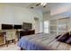 Bedroom features an en-suite bathroom, two closets, and large dresser with TV at 592 Deer W Run, Palm Harbor, FL 34684
