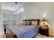 Main bedroom features king bed, high ceiling, and unique arched window for natural light at 592 Deer W Run, Palm Harbor, FL 34684