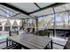 Enclosed patio featuring dining table, lounge chairs, outdoor grill and spa, perfect for relaxing and entertaining outdoors at 592 Deer W Run, Palm Harbor, FL 34684