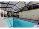 Large screened-in pool with outdoor seating, perfect for backyard relaxation and entertaining at 592 Deer W Run, Palm Harbor, FL 34684