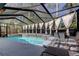 Sparkling screened pool with spa, lounge chairs, and privacy curtains for relaxing and enjoying the outdoors at 592 Deer W Run, Palm Harbor, FL 34684