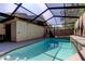 Spacious screened pool with spa and outdoor seating, perfect for relaxing and entertaining year-round at 592 Deer W Run, Palm Harbor, FL 34684