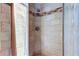 Tiled walk-in shower featuring a rain shower head and a decorative band, complete with a glass door at 592 Deer W Run, Palm Harbor, FL 34684