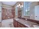 Bathroom featuring dual sinks, granite countertops and tiled shower and bathtub at 6036 Fishhawk Crossing Blvd, Lithia, FL 33547