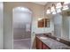 Bathroom with a granite countertop vanity, shower stall, and a view into the walk-in closet at 6036 Fishhawk Crossing Blvd, Lithia, FL 33547