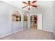 Bedroom featuring a ceiling fan and access to other rooms of the home at 6036 Fishhawk Crossing Blvd, Lithia, FL 33547