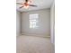 Bedroom featuring a ceiling fan, neutral carpet and wall color and window at 6036 Fishhawk Crossing Blvd, Lithia, FL 33547