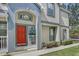 Townhouse exterior featuring a bright red front door at 6036 Fishhawk Crossing Blvd, Lithia, FL 33547