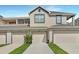 Townhouse exterior featuring three garage doors at 6036 Fishhawk Crossing Blvd, Lithia, FL 33547