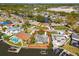 Aerial view of waterfront property with seawall and boat dock on canal surrounded by lush landscaping and neighborhood at 8706 Tahiti Ln, Tampa, FL 33615