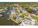 Scenic aerial view of canal-front neighborhood with houses, boat docks, and waterfront access at 8706 Tahiti Ln, Tampa, FL 33615