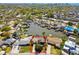 Aerial view of a waterfront home with nearby boat docks and lush landscaping at 8706 Tahiti Ln, Tampa, FL 33615