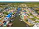 Stunning aerial view of a waterfront community with homes, canals, boat docks, and easy water access at 8706 Tahiti Ln, Tampa, FL 33615