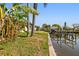 Canal-front property featuring a private dock, waterfront access, and lush greenery at 8706 Tahiti Ln, Tampa, FL 33615