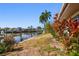 Scenic view of canal-front property with dock and lush greenery in a peaceful neighborhood at 8706 Tahiti Ln, Tampa, FL 33615
