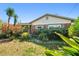 Charming single-story home with brick facade and mature landscaping at 8706 Tahiti Ln, Tampa, FL 33615