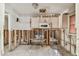 Incomplete kitchen remodeling with white tile floor and cabinets above microwave at 8706 Tahiti Ln, Tampa, FL 33615