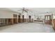Empty living room featuring large window, ceiling fan, and front door at 8706 Tahiti Ln, Tampa, FL 33615