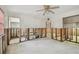 Unfinished living room with removed drywall, ceiling fan, and tile flooring at 8706 Tahiti Ln, Tampa, FL 33615