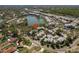 Aerial view showcases this neighborhood's well-maintained buildings near a serene lake and lush greenery at 9037 Pebble Creek Dr, Tampa, FL 33647