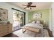 Relaxing bedroom with ceiling fan and sliding glass door to private patio at 9037 Pebble Creek Dr, Tampa, FL 33647