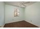 A bedroom is illuminated by a window and features hardwood floors at 9037 Pebble Creek Dr, Tampa, FL 33647