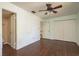 The bedroom features hardwood flooring, a closet, and an ensuite bathroom at 9037 Pebble Creek Dr, Tampa, FL 33647