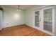 Cozy dining area illuminated by modern lighting and French doors at 9037 Pebble Creek Dr, Tampa, FL 33647