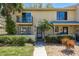 Charming townhouse with private balcony, tropical landscaping, and inviting entrance at 9037 Pebble Creek Dr, Tampa, FL 33647