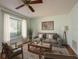 Comfortable living room with fan, couch, and window offering natural light at 9037 Pebble Creek Dr, Tampa, FL 33647