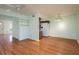 Open living room with hardwood floors, a ceiling fan, and a clear view of the kitchen at 9037 Pebble Creek Dr, Tampa, FL 33647