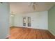Bright living room features hardwood floors, a ceiling fan, and double doors to a patio at 9037 Pebble Creek Dr, Tampa, FL 33647
