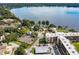 Beautiful aerial view of a multi-unit residential complex with tennis courts and lake access at 94 S Highland Ave # 2402, Tarpon Springs, FL 34689