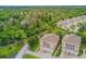 Aerial view of a real estate community with lush greenery and winding roads at 94 S Highland Ave # 2402, Tarpon Springs, FL 34689