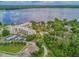 Birds-eye view of the property offering lush landscaping and proximity to the serene lake at 94 S Highland Ave # 2402, Tarpon Springs, FL 34689