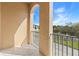 This is a condo balcony with an arched opening and a view of the neighborhood at 94 S Highland Ave # 2402, Tarpon Springs, FL 34689