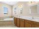 Primary bathroom with double sinks, wooden cabinets, tiled flooring and separate bathtub at 94 S Highland Ave # 2402, Tarpon Springs, FL 34689