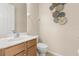 Powder room featuring a modern vanity, toilet, and decorative wall art at 94 S Highland Ave # 2402, Tarpon Springs, FL 34689