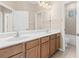 Bright bathroom with double sinks, wood cabinets, and a large mirror at 94 S Highland Ave # 2402, Tarpon Springs, FL 34689