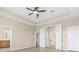 This main bedroom features a ceiling fan, wood floors, and en suite bathroom and closet at 94 S Highland Ave # 2402, Tarpon Springs, FL 34689