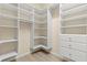 Walk-in closet with built-in shelving and drawers provides ample storage space at 94 S Highland Ave # 2402, Tarpon Springs, FL 34689